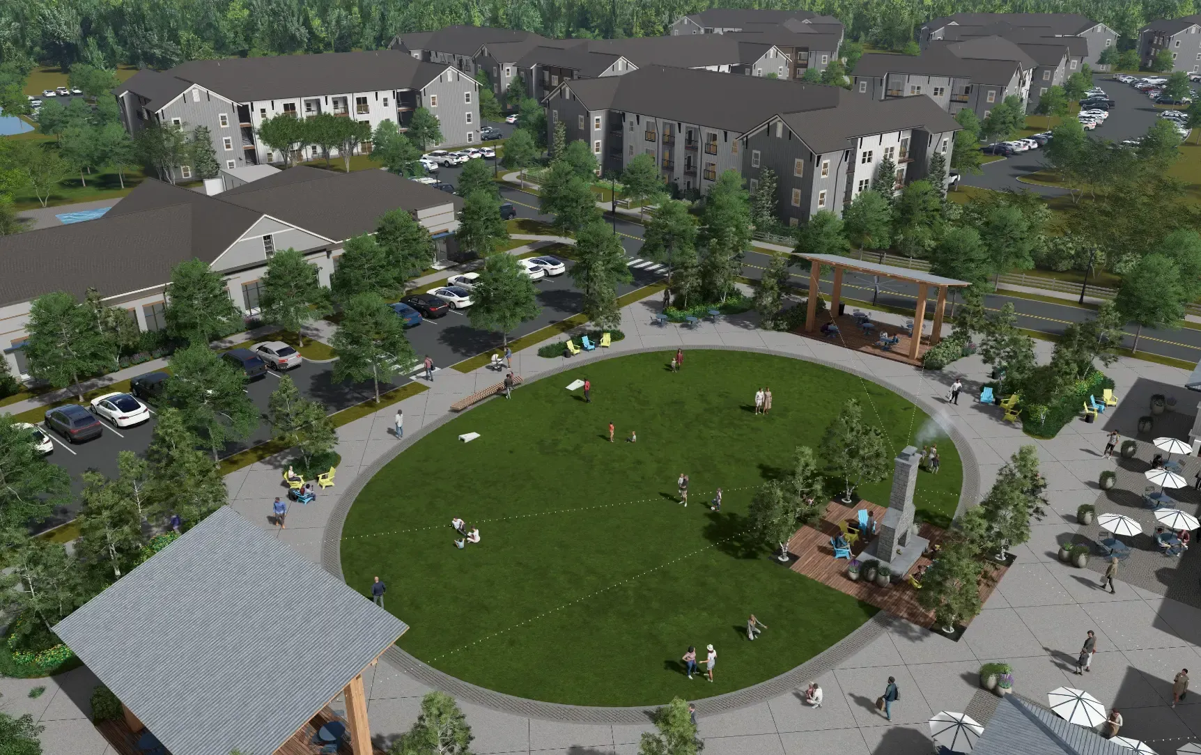 Aerial view of a residential courtyard with a large grassy circle, sidewalks, trees, and apartment buildings.