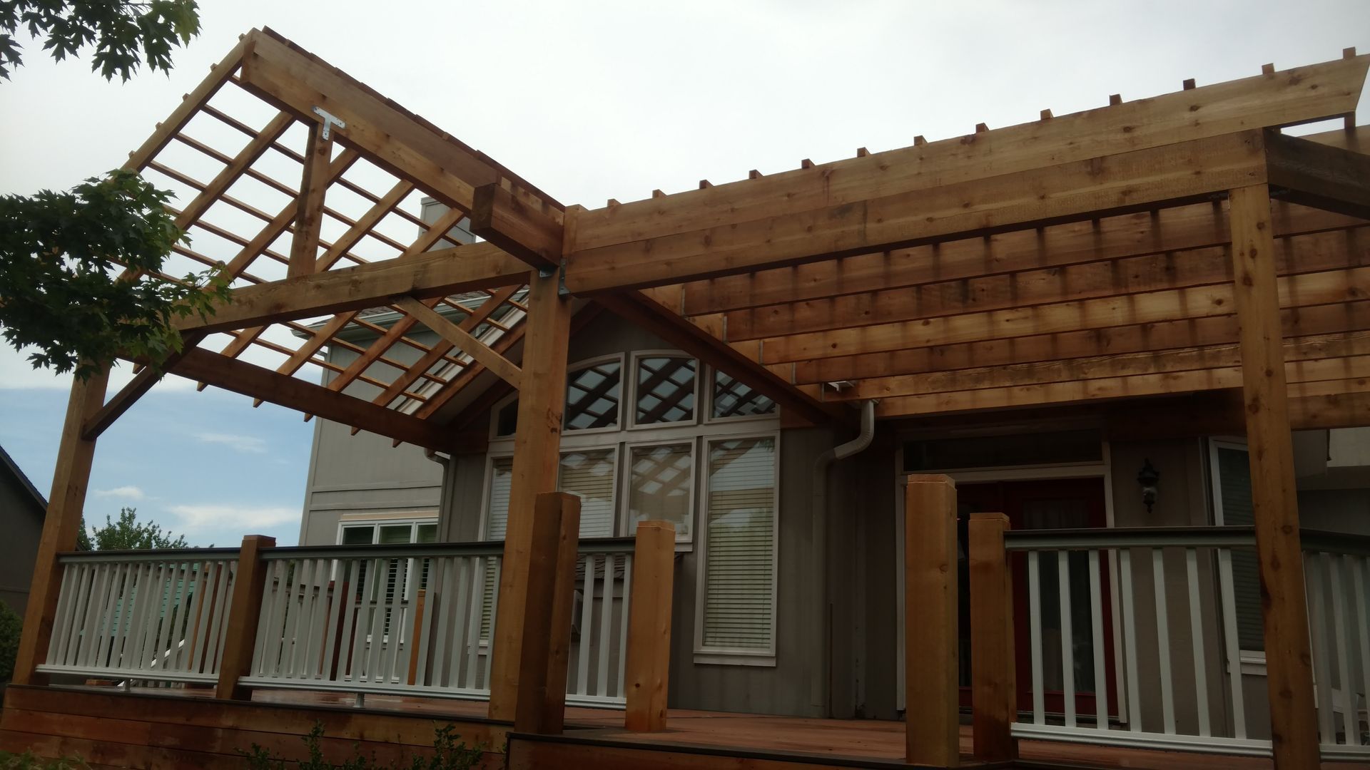 Damaged porch roof with exposed wooden framing on a house under repair
