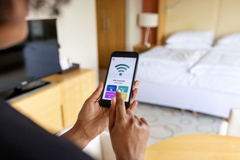 A woman is using a tablet to control a smart home. A woman is using a tablet to control a smart home.