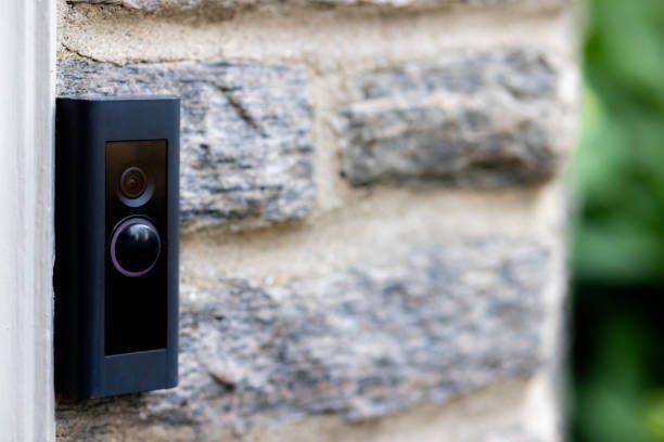 A doorbell is attached to a brick wall.