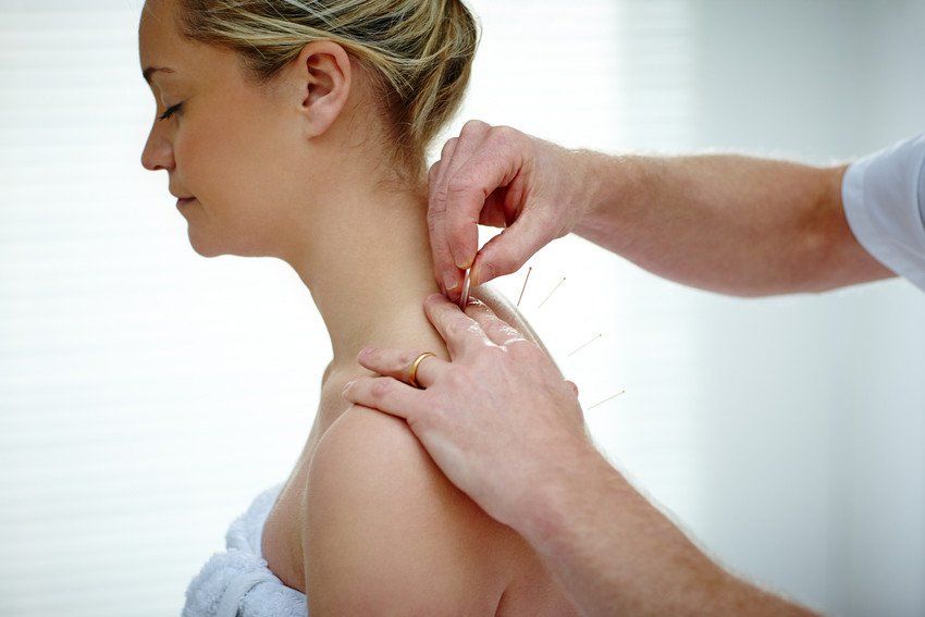 Lady receiving acupuncture treatment