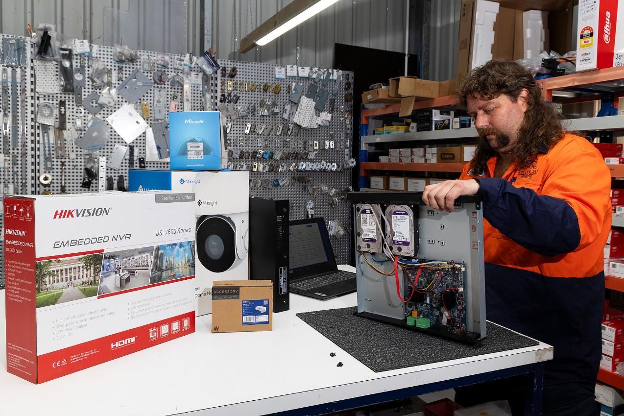 Man With Mullet Assembles a Computer. Boxes and Parts — Active 247 Locksmith and Security Services Forster In Forster, NSW