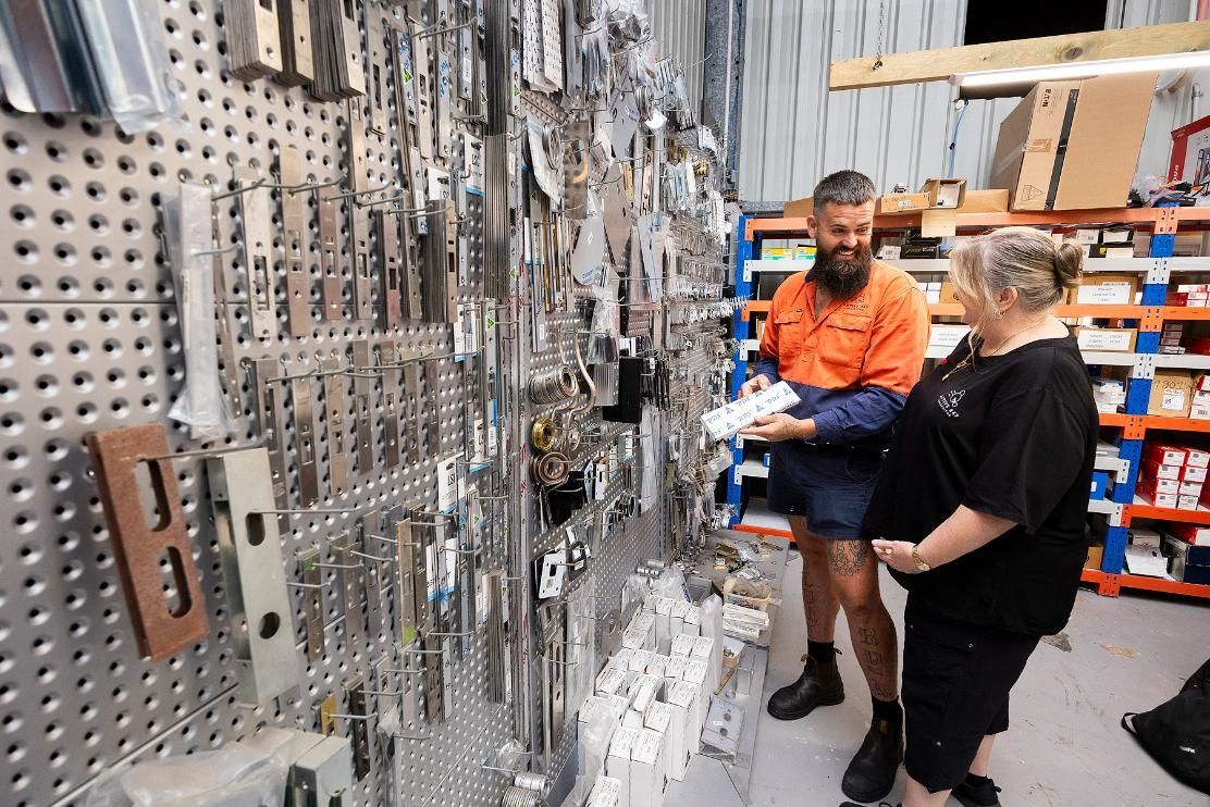 Man With Beard and Woman Looking at Hardware Display — Active 247 Locksmith and Security Services Forster In Seal Rocks, NSW