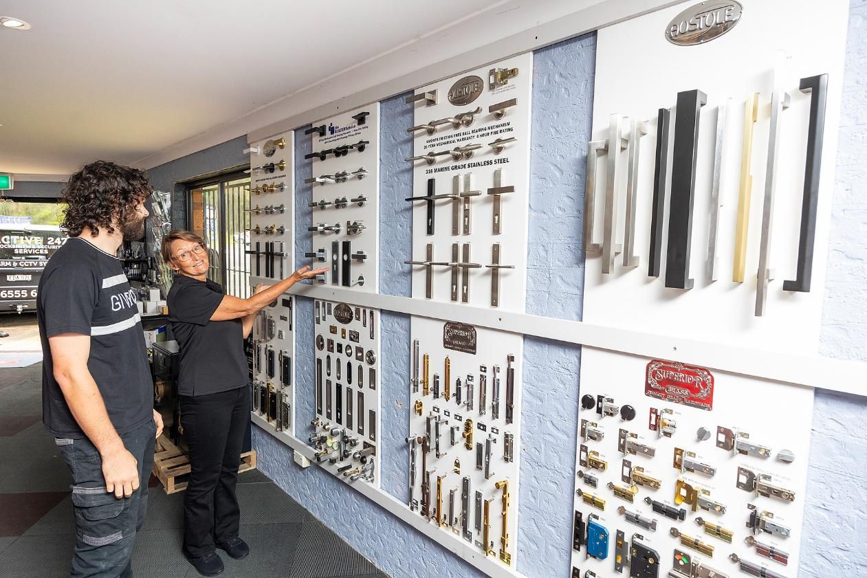 A Woman Points at Door Handles — Active 247 Locksmith and Security Services Forster In Hallidays Point, NSW