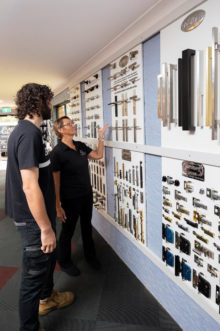 A Man and Woman Looking at Door Hardware Samples — Active 247 Locksmith and Security Services Forster In Old Bar, NSW