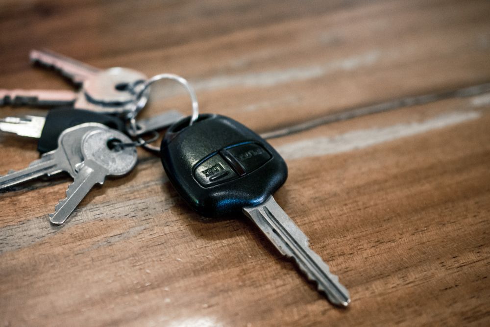 Keys on a Wooden Surface, Including a Car Key — Active 247 Locksmith and Security Services Forster In Nabiac, NSW