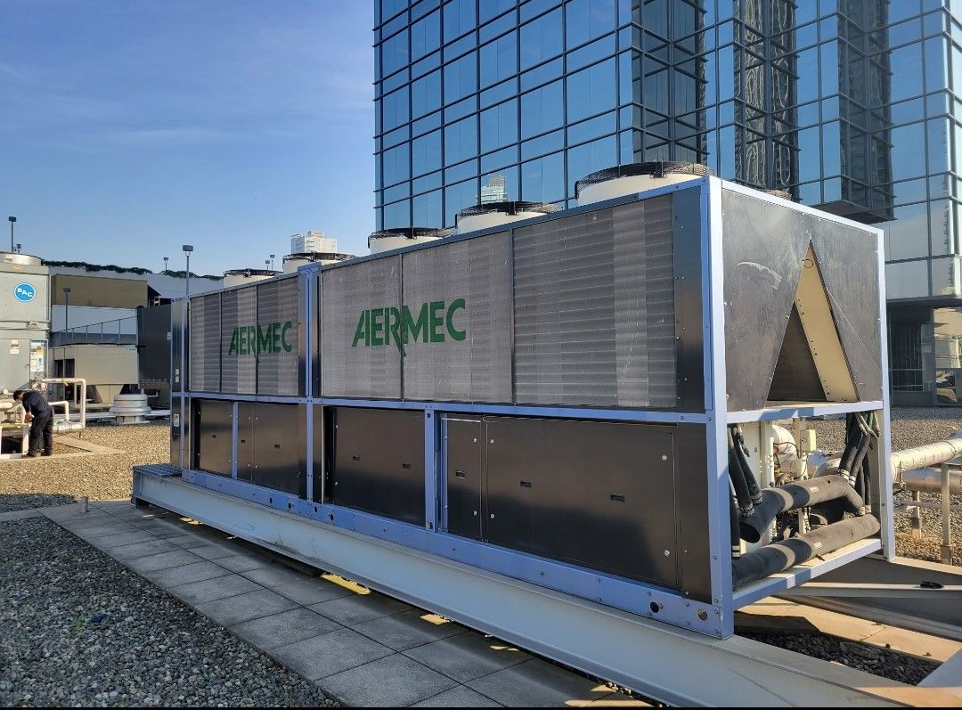 Photo of Aermec pumped refrigerant unit on top of roof.