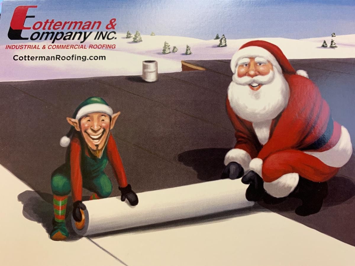 Santa and an elf rolling out a roof. Snowy scene.