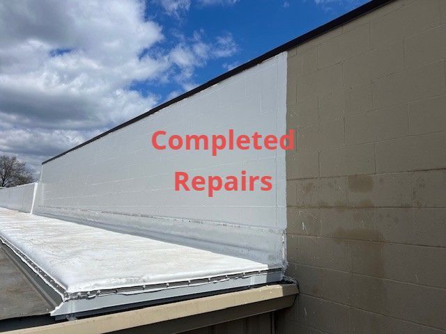 Completed repairs text over a white rooftop edge against blue sky