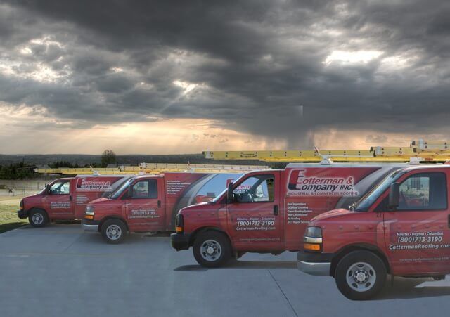 Four red work vans with