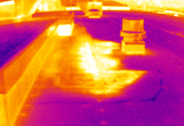 Thermal image of a roof showing warm areas in orange/yellow and cooler areas in purple.