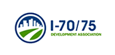 Logo for I-70/75 Development Association: a blue circle with a cityscape above green roads