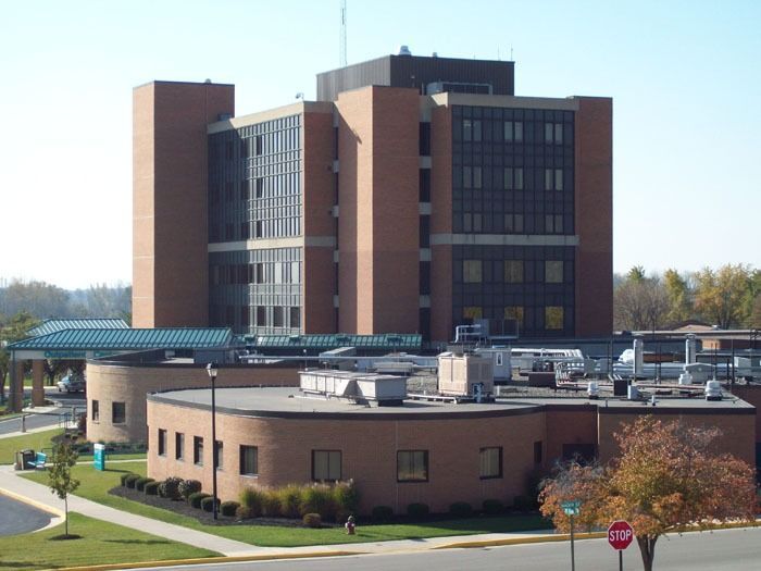 Hospital building with brick exterior, multiple stories, and rounded front sections.