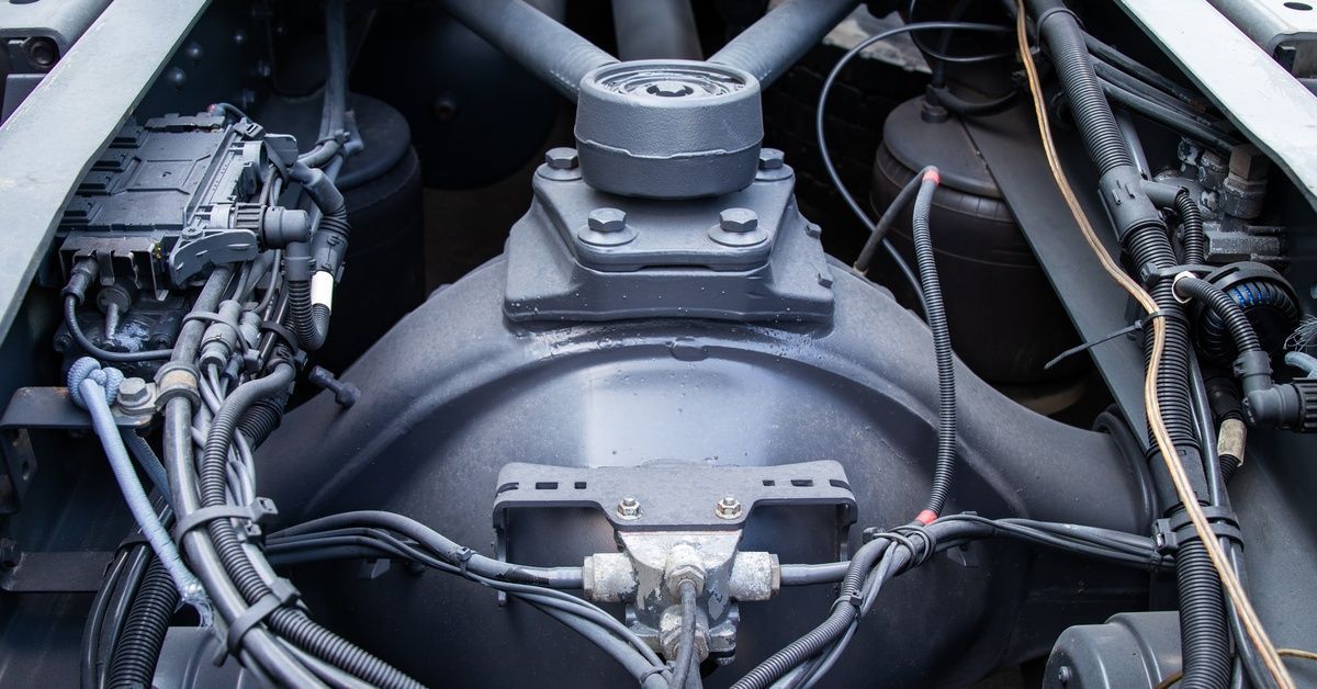 An up-close shot of a truck's rear frame highlighting all the complex details of the pneumatic system and axle suspension.