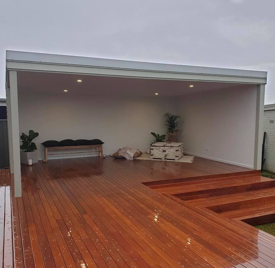 A Large Wooden Deck With A Pergola Over It — J.White Carpentry & Renovations in Port Macquarie, NSW 