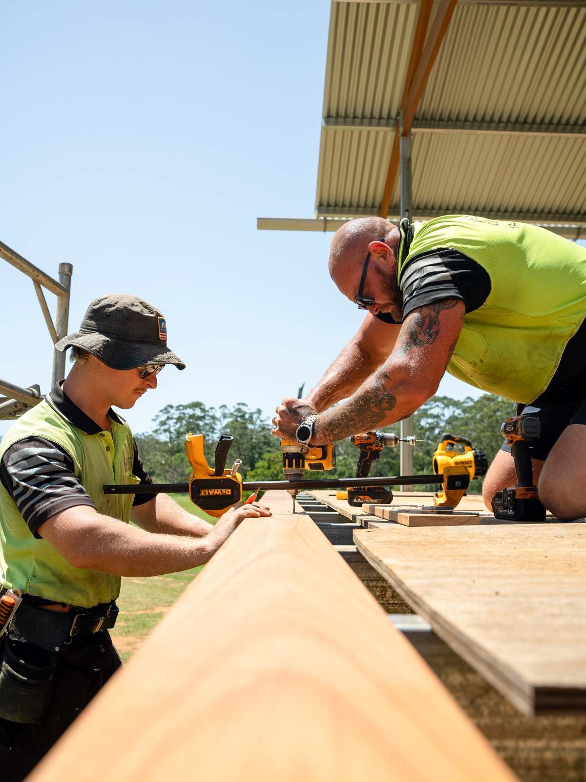 Two men are working on a piece of wood  — J.White Carpentry & Renovations in Port Macquarie, NSW