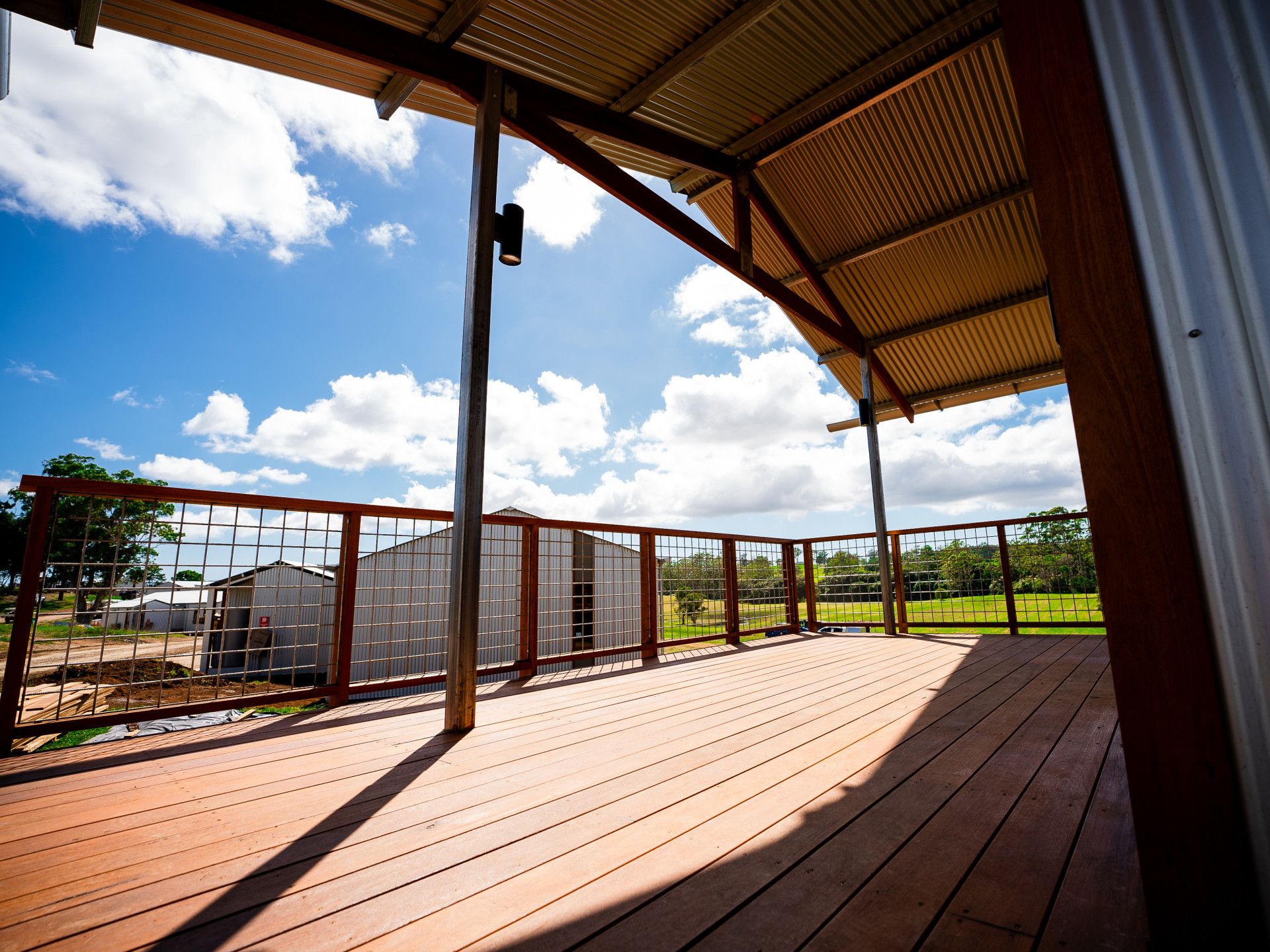 Large Wooden Deck In The Backyard Of A House — J.White Carpentry & Renovations in Port Macquarie, NSW
