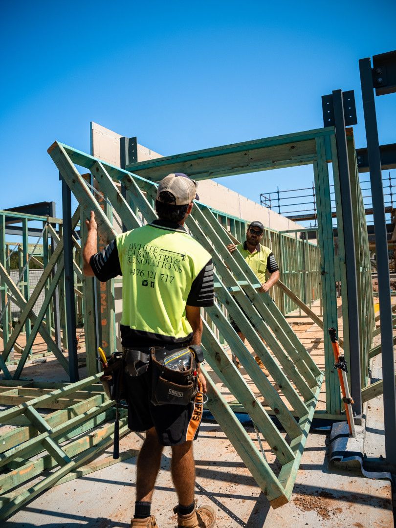 Two Carpenters Working On A Home Wooden Construction — J.White Carpentry & Renovations in Port Macquarie, NSW