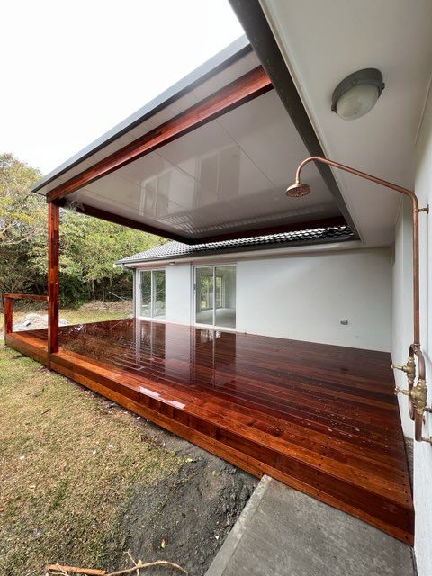 A Large Wooden Deck With A Shower Attached To It — J.White Carpentry & Renovations in Port Macquarie, NSW