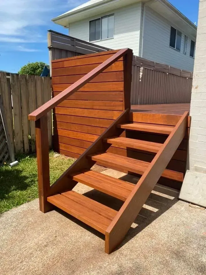 A wooden staircase leading up to a deck in front of a house. — J.White Carpentry & Renovations in Port Macquarie, NSW