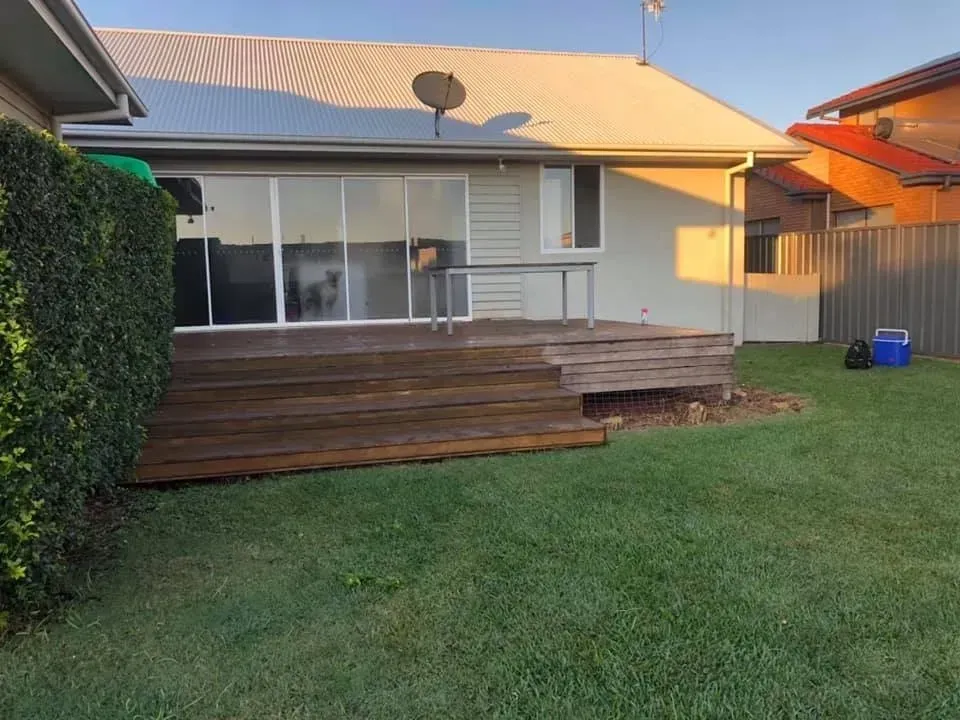 A house with a wooden deck in the backyard — J.White Carpentry & Renovations in Port Macquarie, NSW 