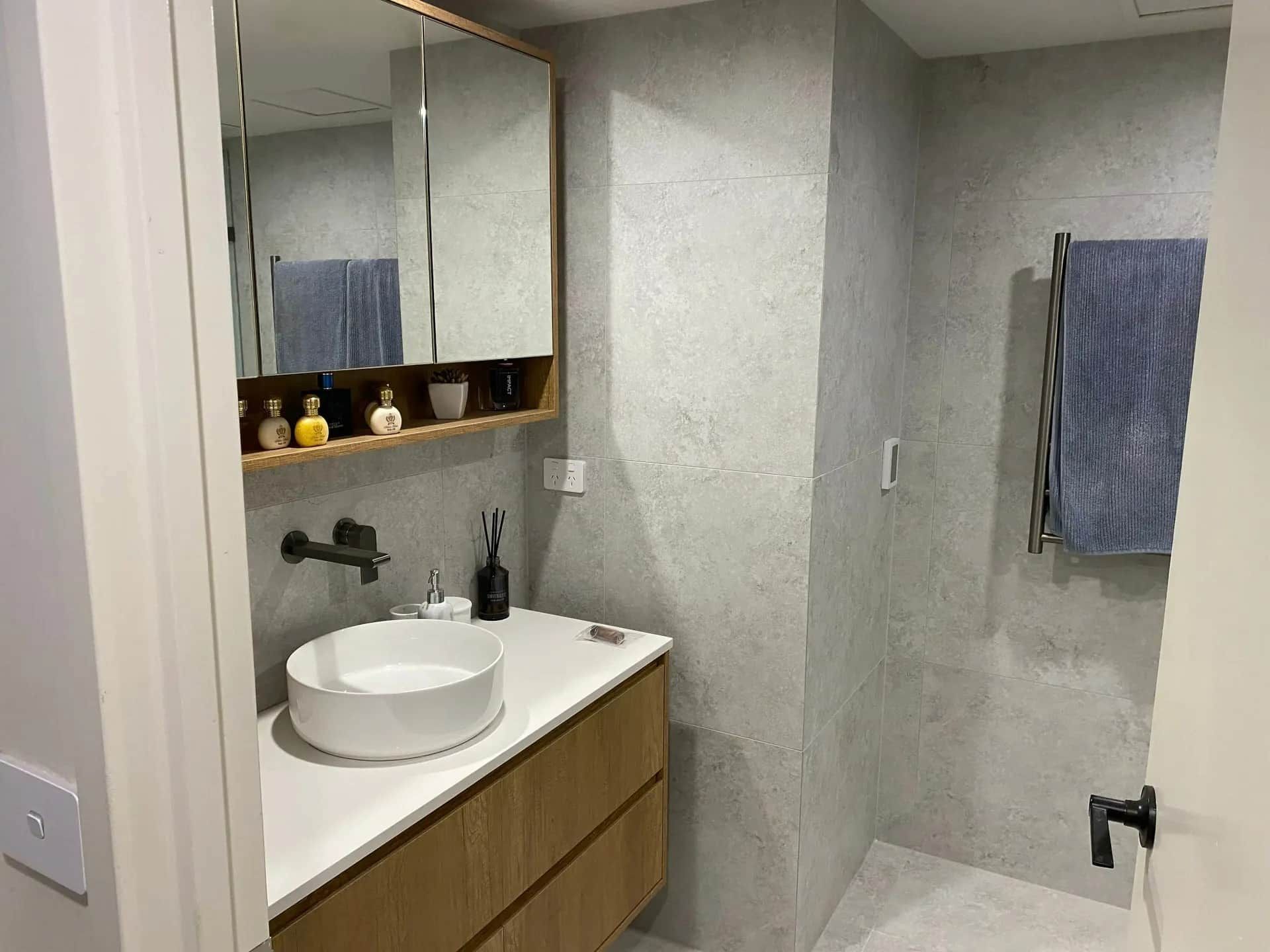 A Bathroom With A Sink , Mirror And Towel Rack — Andy Dennis Carpentry In Banora Point, NSW 
