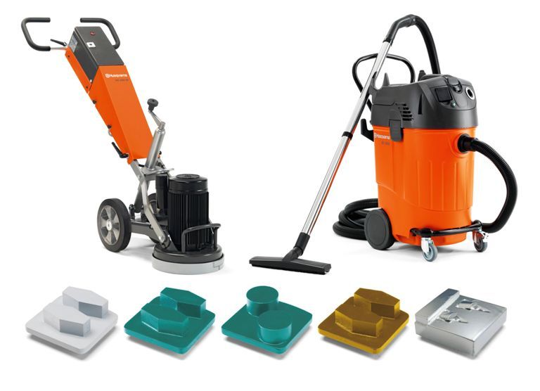 Orange and black industrial vacuum with attachments displayed on a white background