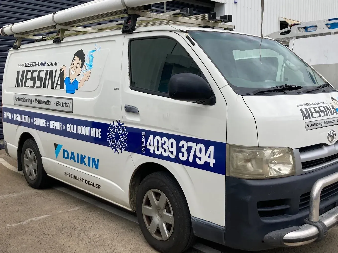 Two White Messina Air Conditioning Vans Parked on A Street — Messina Air Conditioning & Electrical in Portsmith, QLD