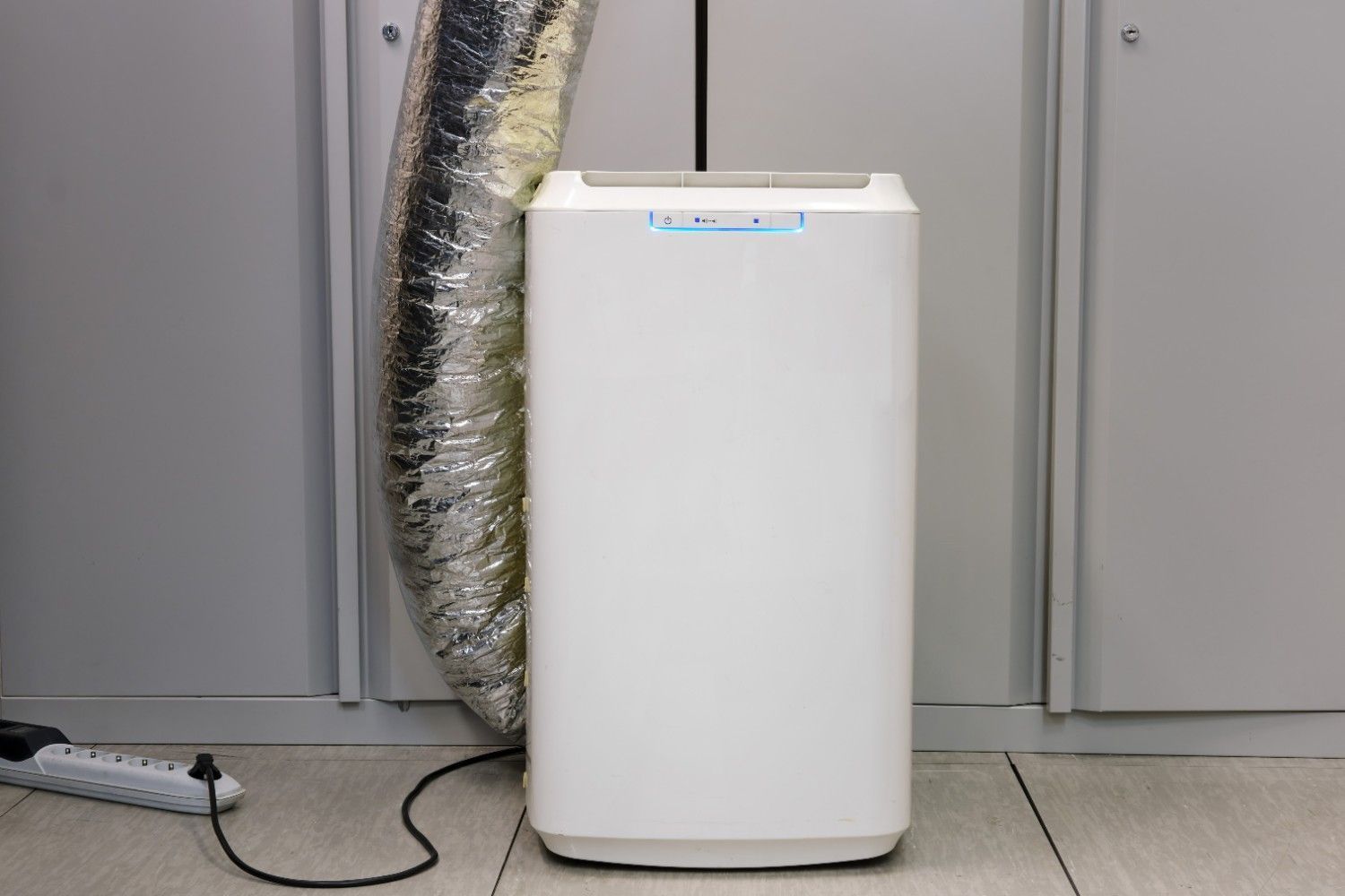 White Air Portable Air Conditioner with Silver Exhaust Hose — Messina Air Conditioning & Electrical in Portsmith, QLD