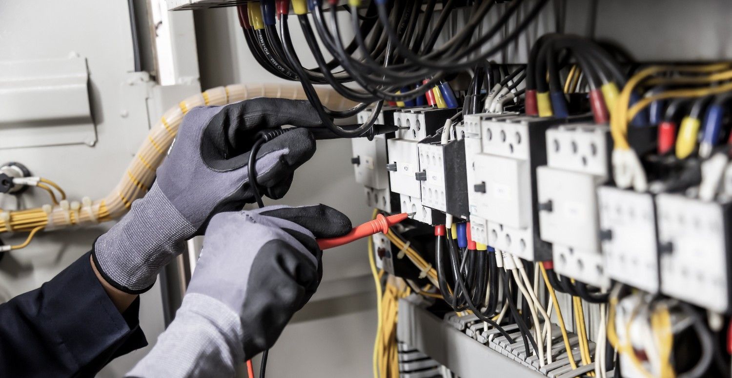 Electrician Using a Multimeter to Inspect Wires — Messina Air Conditioning & Electrical in Portsmith, QLD