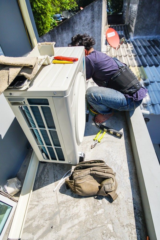 Person on A Rooftop, Installing an AC Unit — Messina Air Conditioning & Electrical in Smithfield, QLD