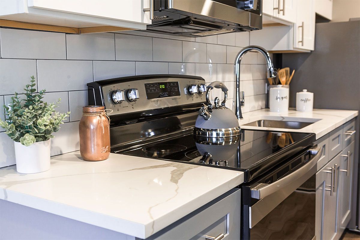 a kitchen with a stove , sink , and microwave .