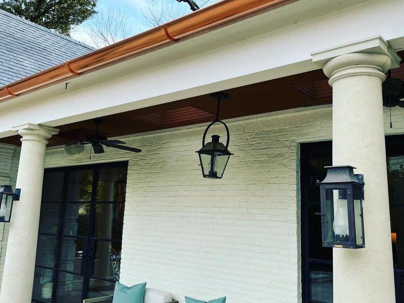 a porch with a couch and lanterns on it