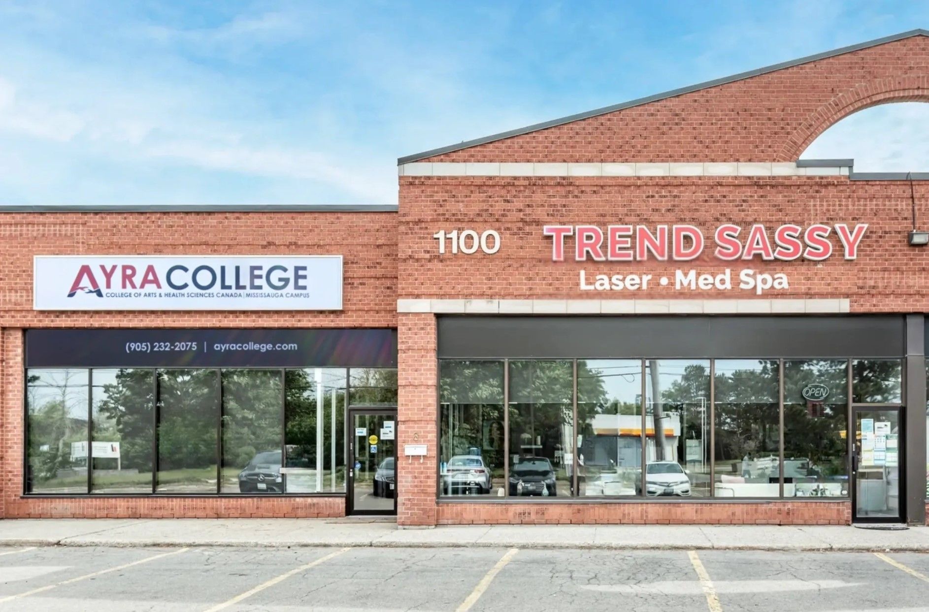 Storefronts for Ayra College and TrendSassy Laser + Med Spa in a brick shopping center