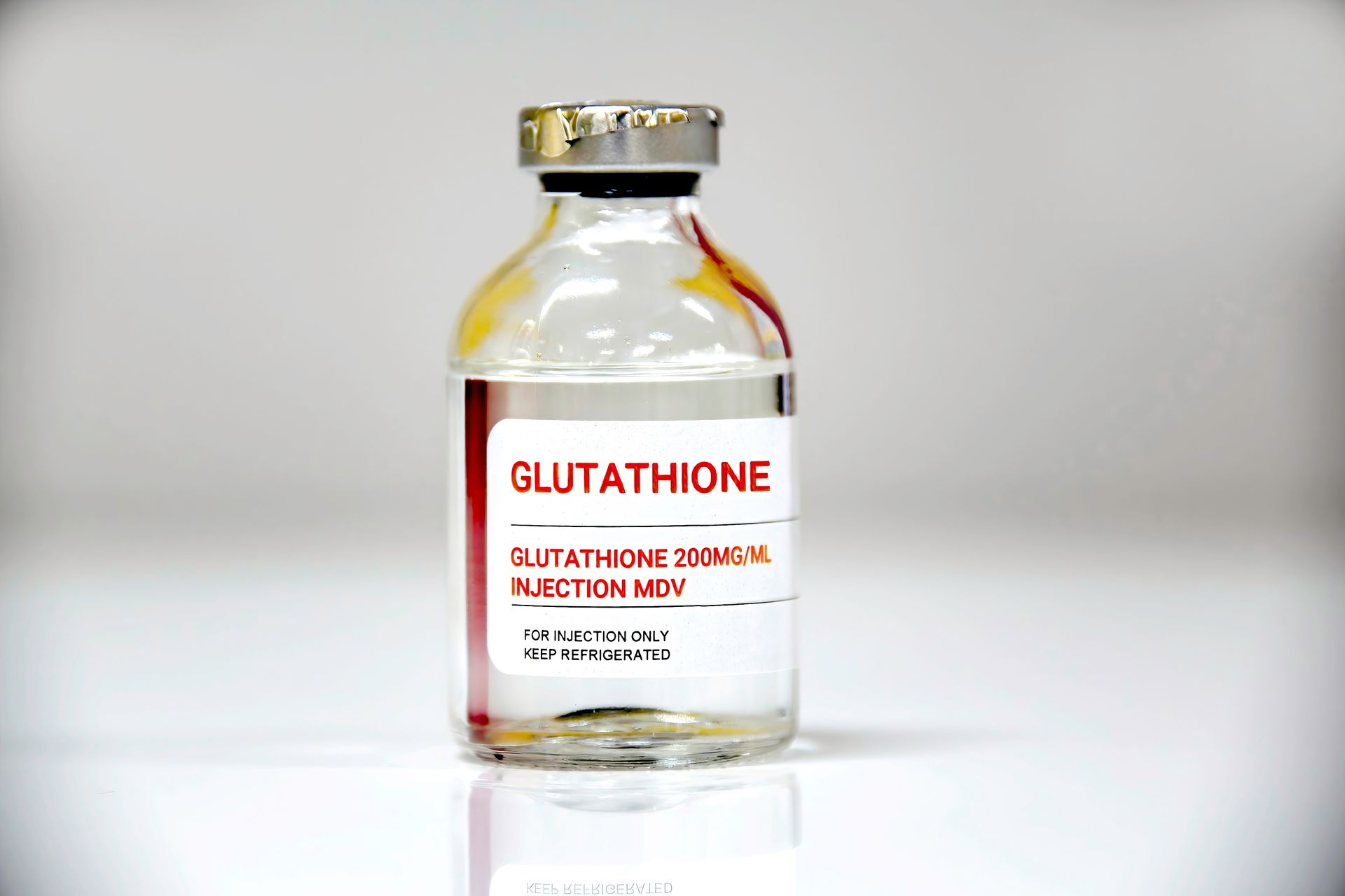 Glutathione injection vial with gold cap on a white background
