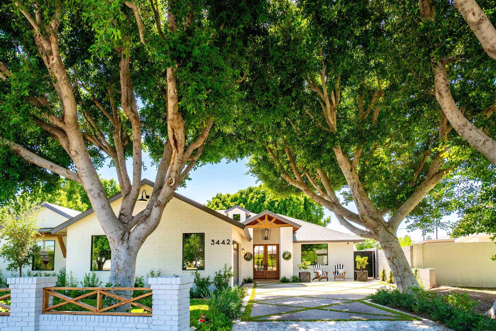 a white house with a lot of trees in front of it