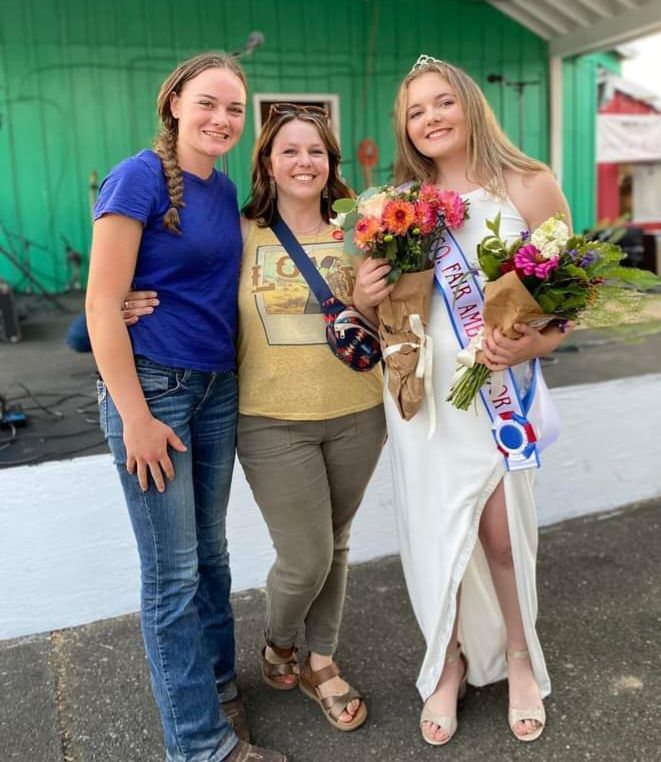 A woman in a white dress is holding a bouquet of flowers