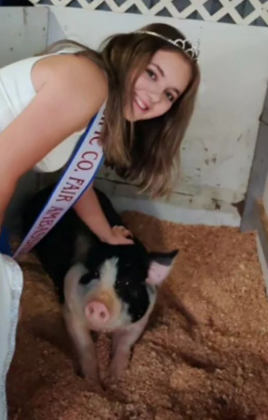 A girl with a sash that says miss co fair on it