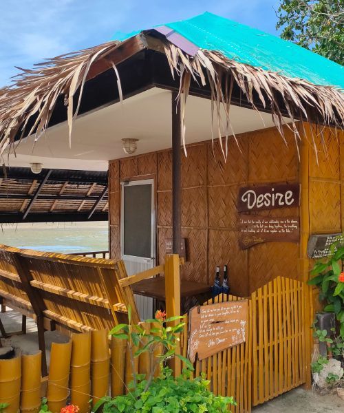 Bamboo hut with a thatched roof on a beach, labeled 