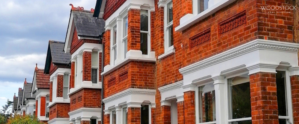 Traditional red brick UK terraced homes with bay windows, Woodstock Legal Services