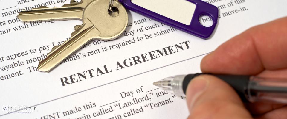 Rental agreement document with house keys, a purple keyring, and a pen ready to sign - Woodstock