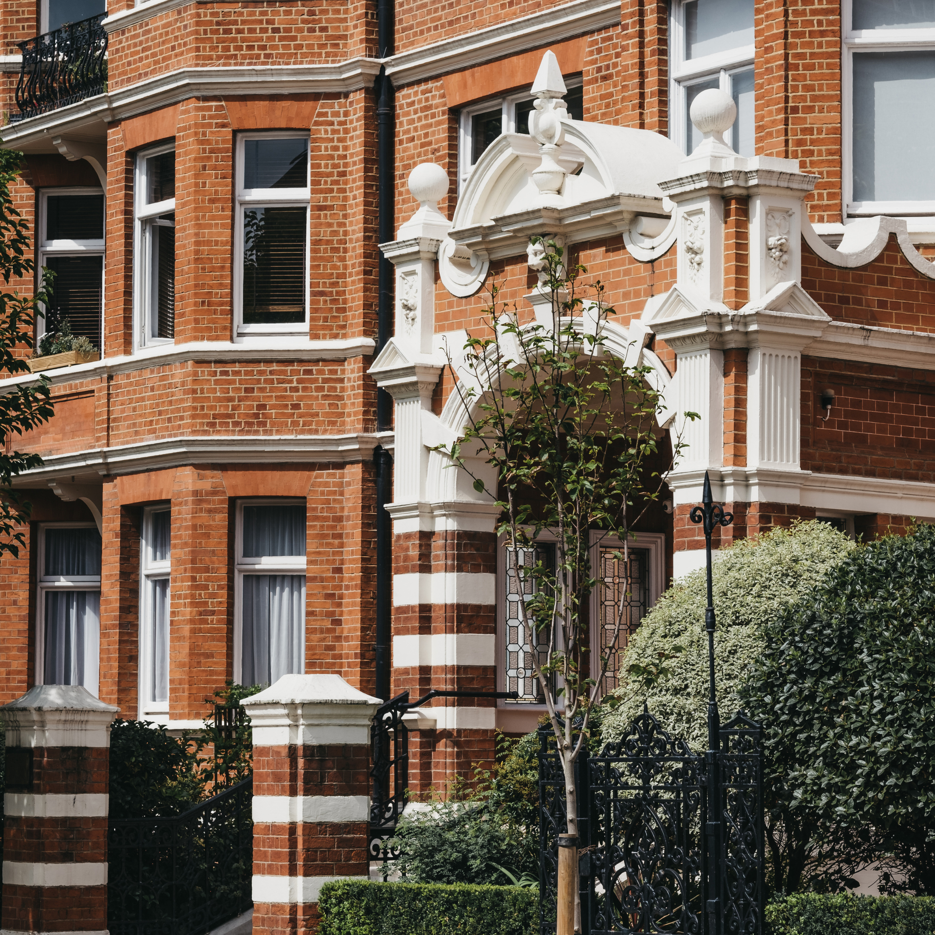 Red-brick terraced houses with city skyline behind