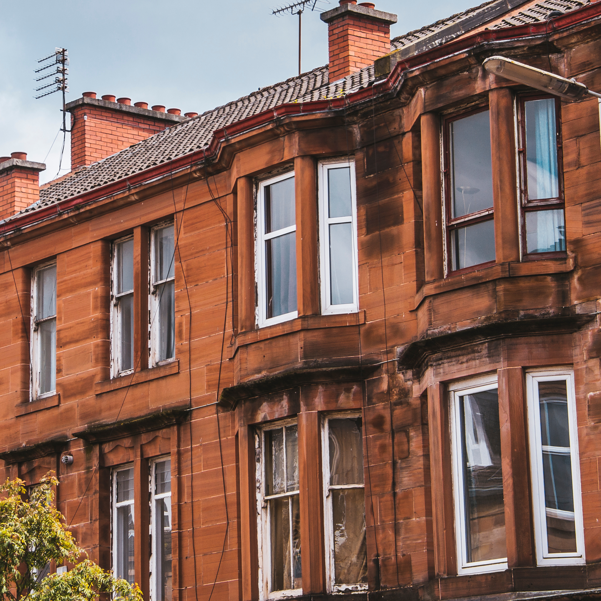 Red sandstone flats with bay windows and chimneys
