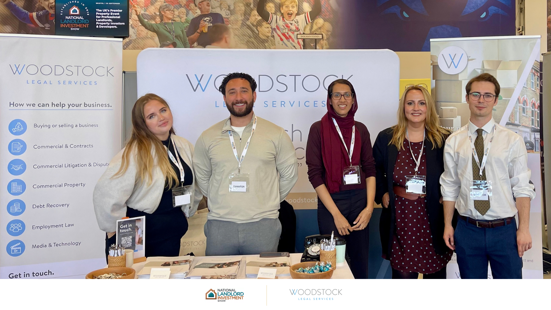 Woodstock Legal Services team of five standing at their exhibition stand at the National Landlord Investment Show in Bristol.