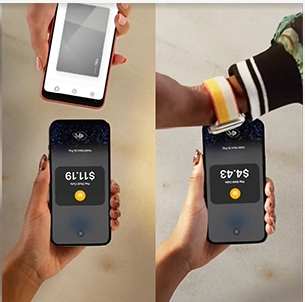 Hand tapping a smartphone Pay button on a glowing payment screen