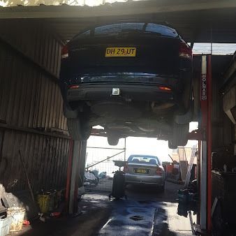 Car on a Lift in a Repair Shop — Argenton Automotive Repairs In Boolaroo, NSW
