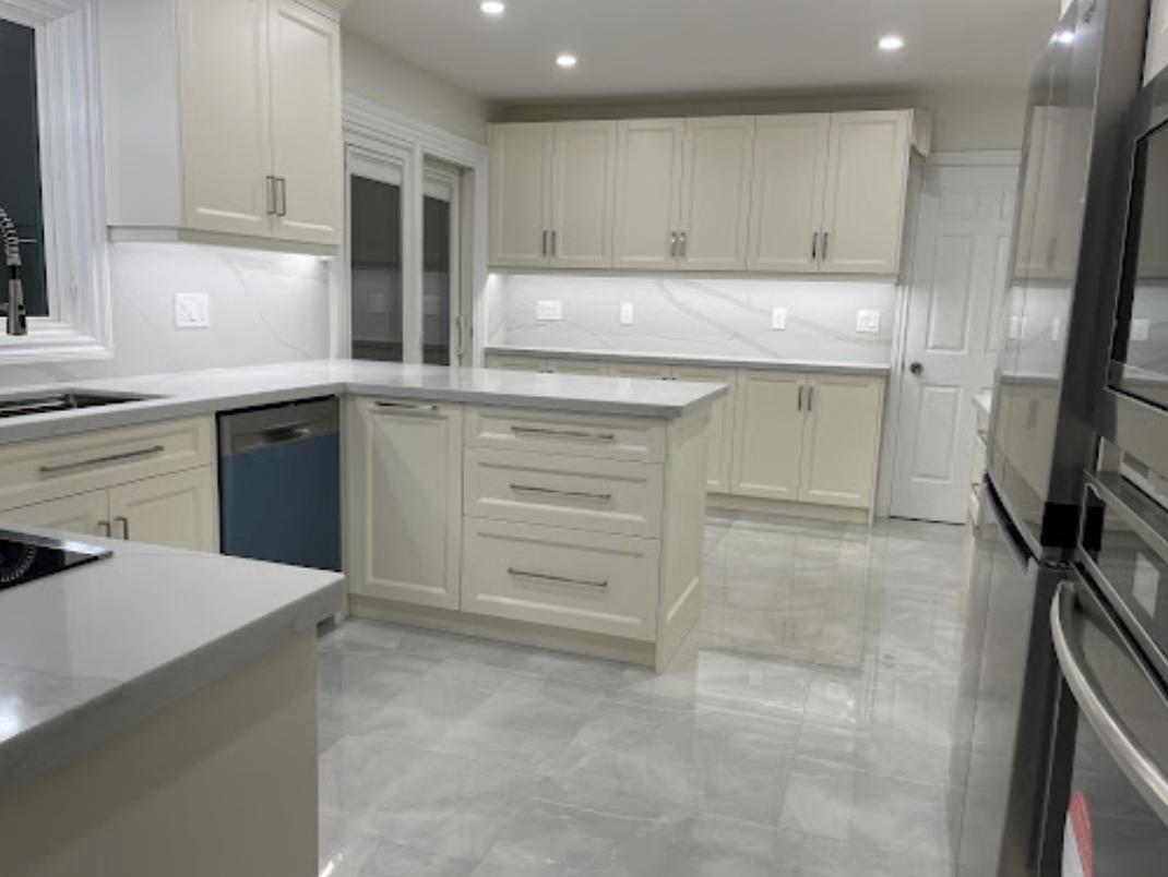 A kitchen with white cabinets and stainless steel appliances.