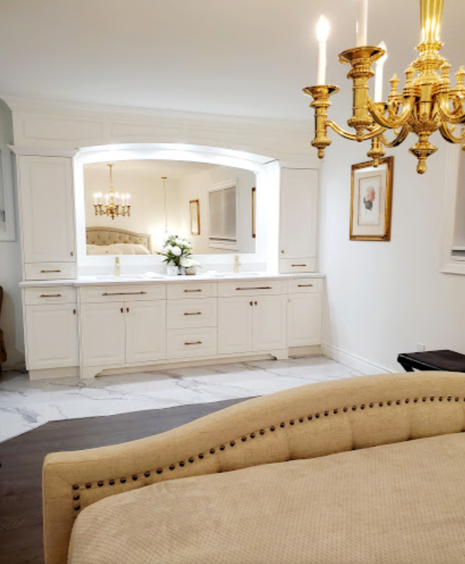 A bedroom with a couch and a chandelier hanging from the ceiling