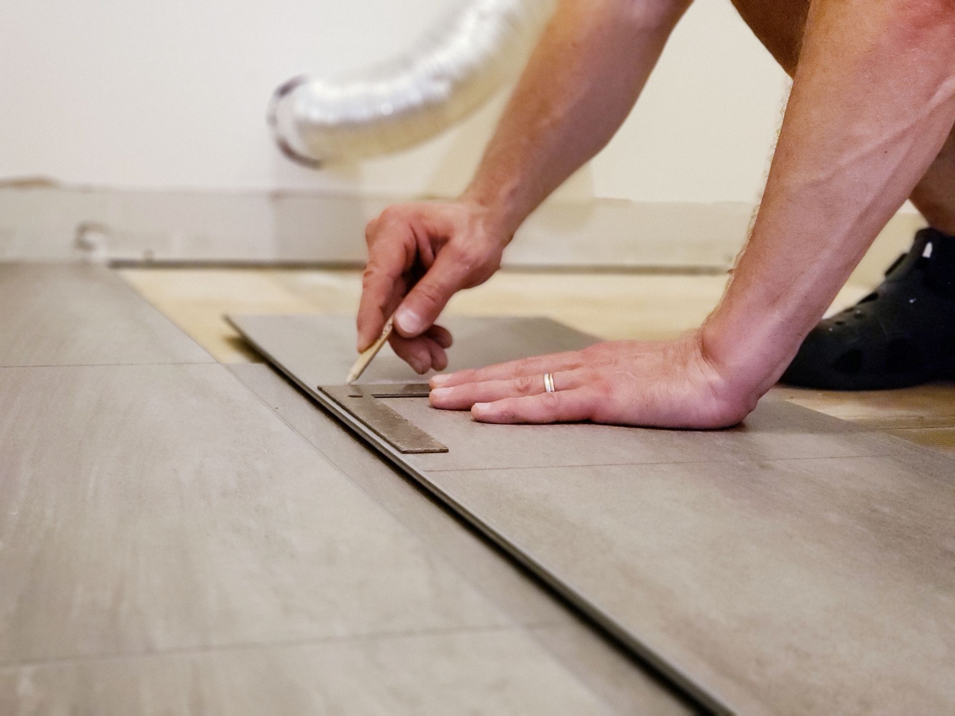 man installing flooring
