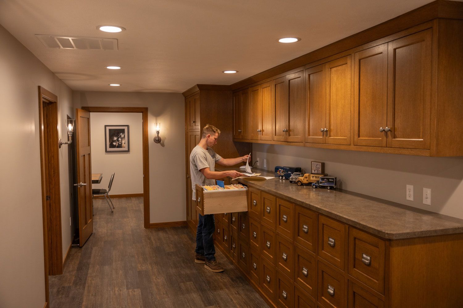 A man is opening a drawer in a kitchen.